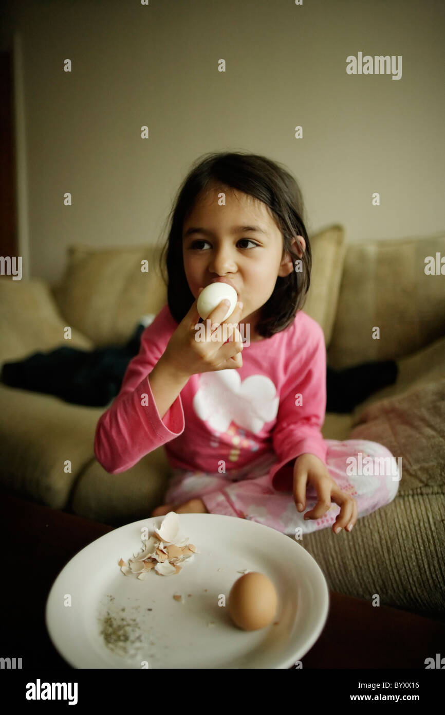 Girl eats hard boiled eggs Stock Photo Alamy