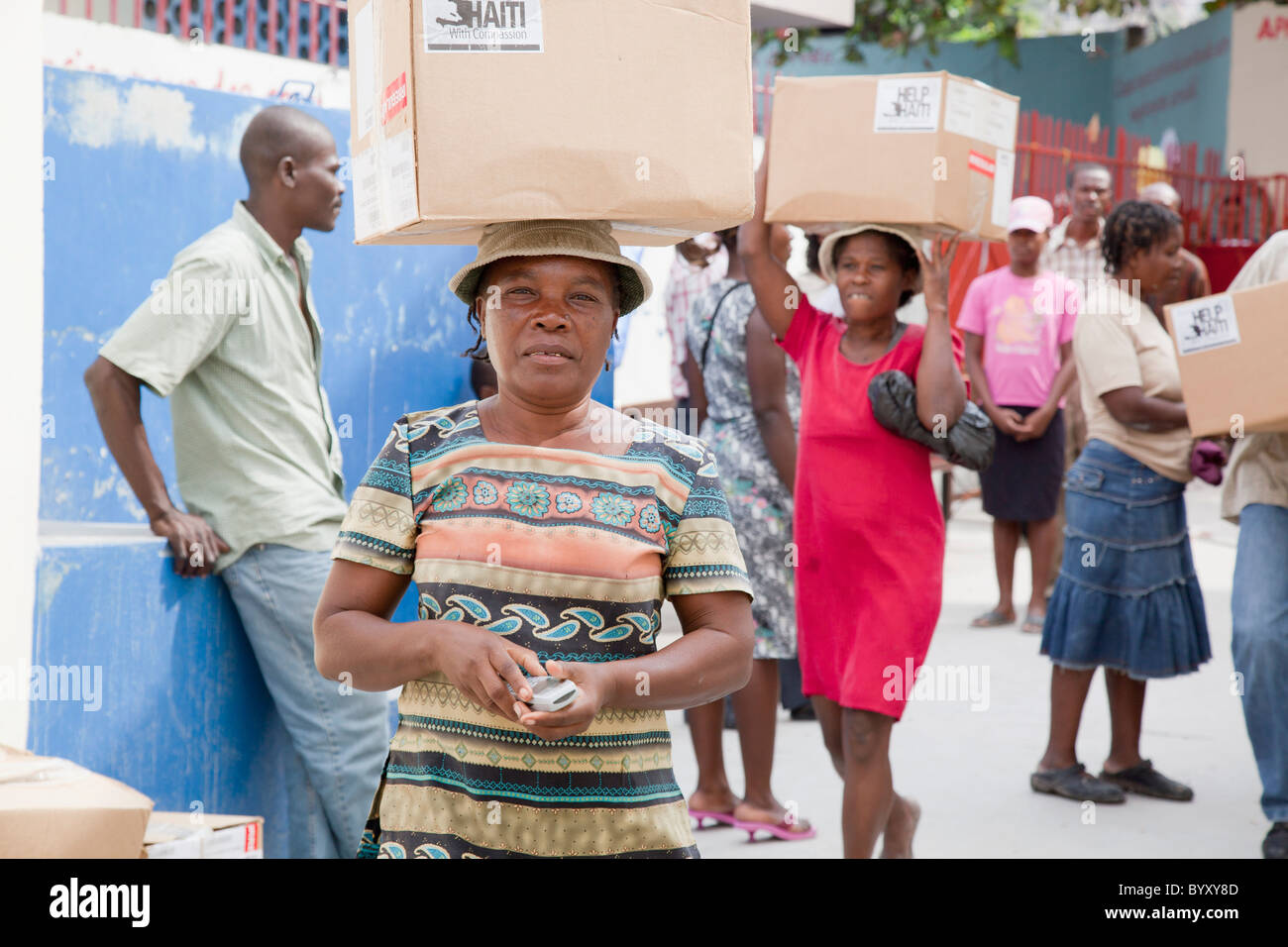 women carrying boxes on their heads through the street; port-au-prince, haiti Stock Photo
