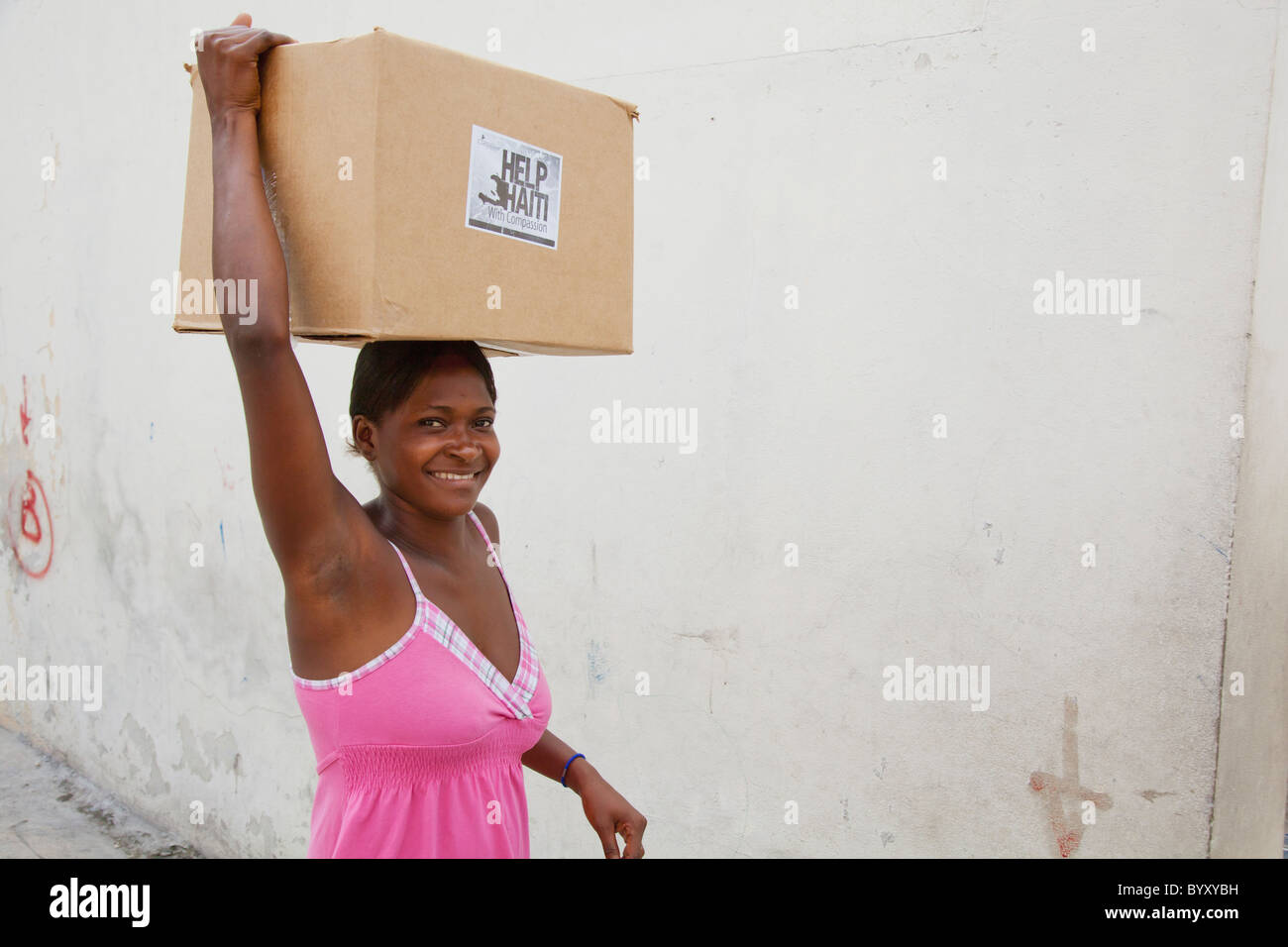 a woman carries a box on her head; port-au-prince, haiti Stock Photo
