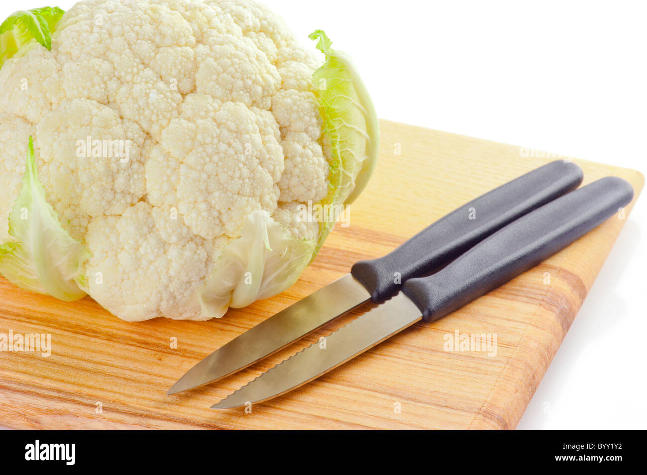 Cauliflower cabbage on wooden cutting board isolated on white background Stock Photo