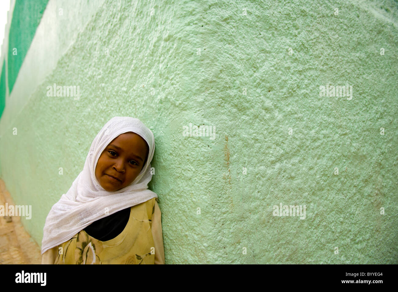 a girl with green wall, harar, ethiopia Stock Photo
