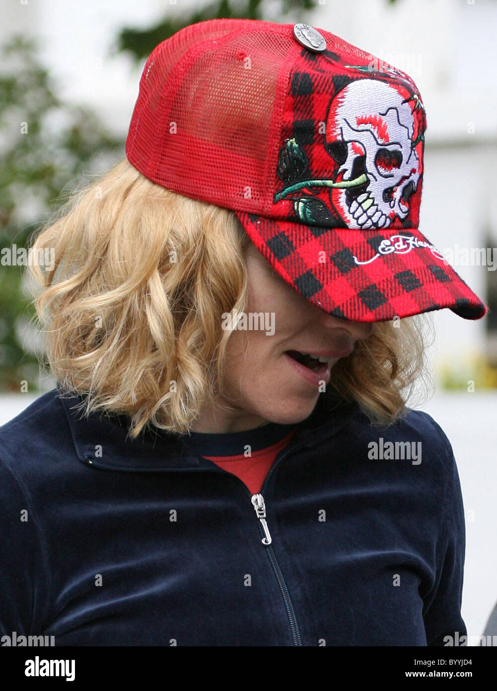 Madonna looking happy as she leaves her gym, wearing a red and black  tracksuit and a cool Ed Hardy red baseball cap. London Stock Photo - Alamy