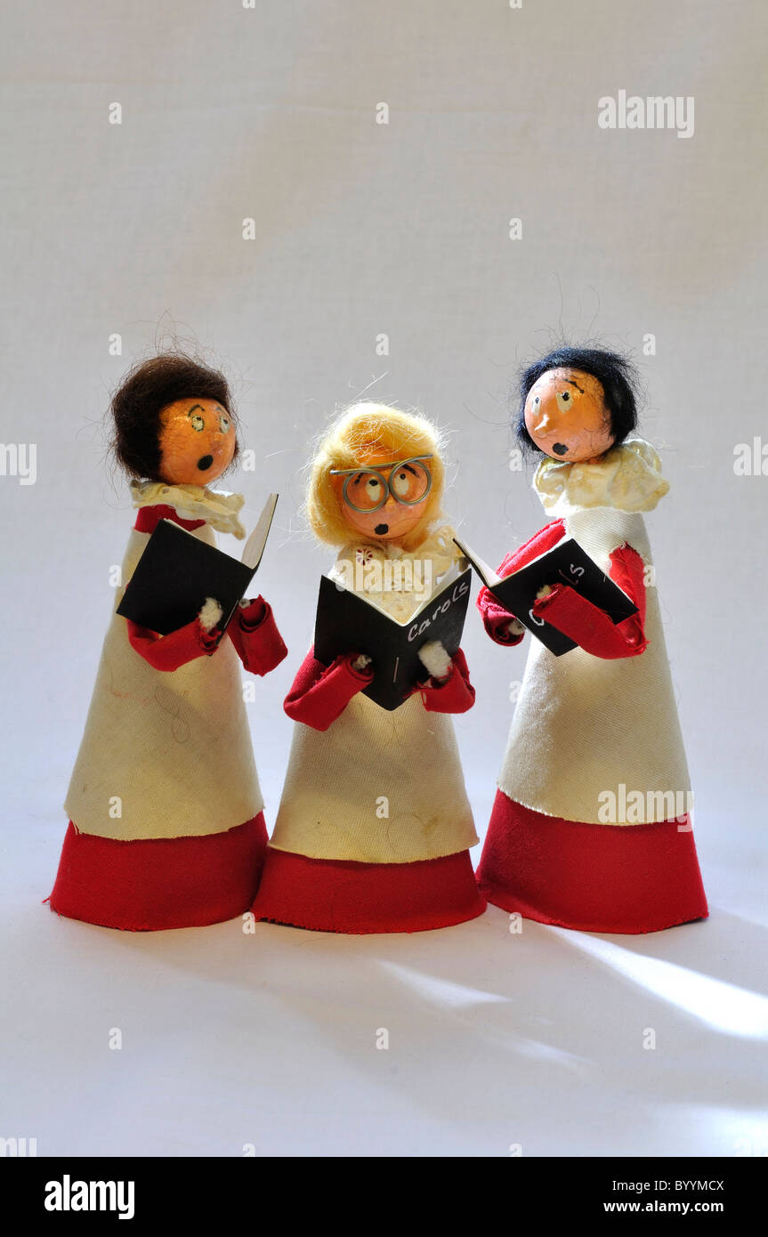 Three choirboys modelled from paper and material, singing carols from carol books. UK December 2010 Stock Photo