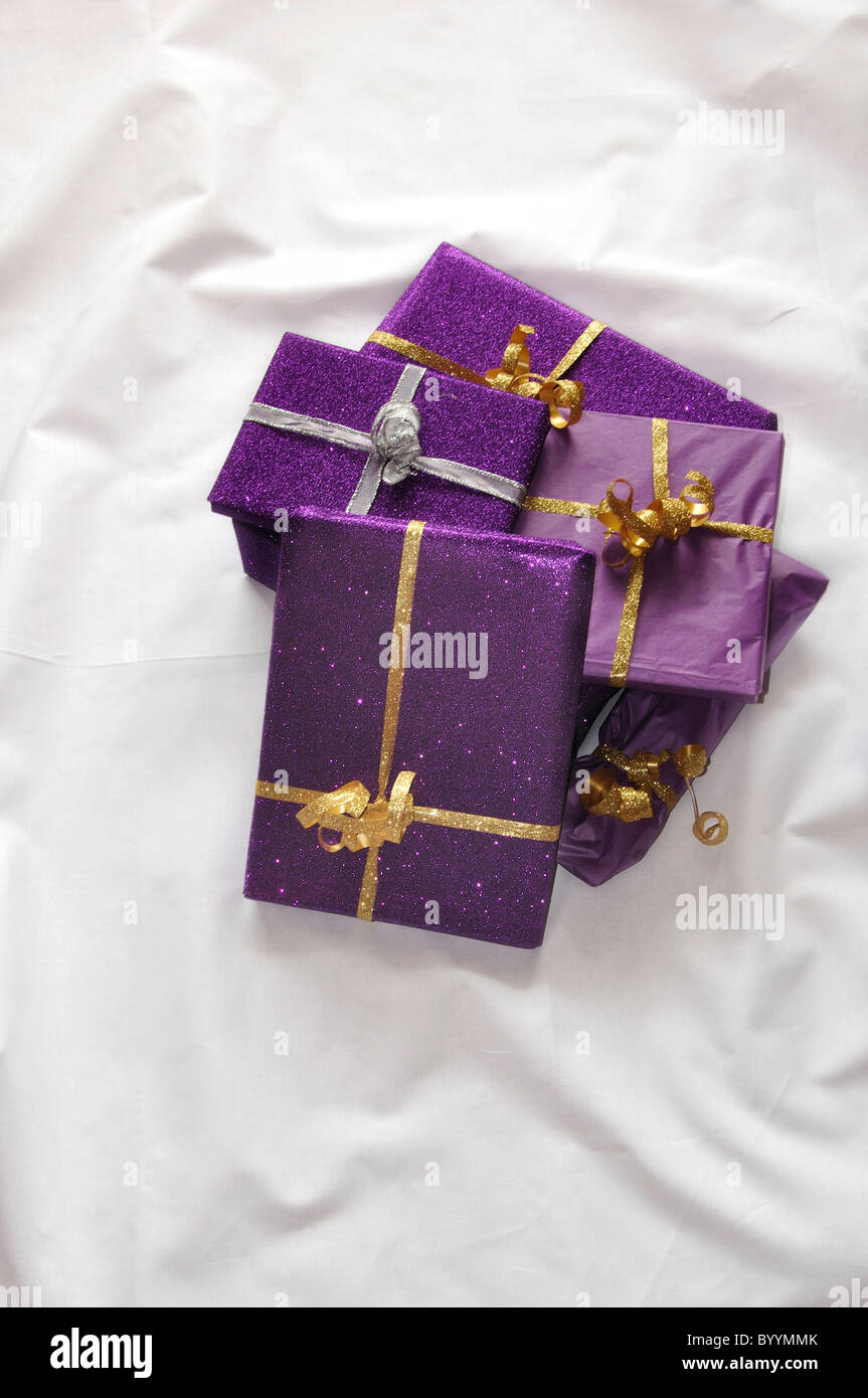 Presents wrapped in purple gift wrapping paper. UK December 2010 Stock Photo