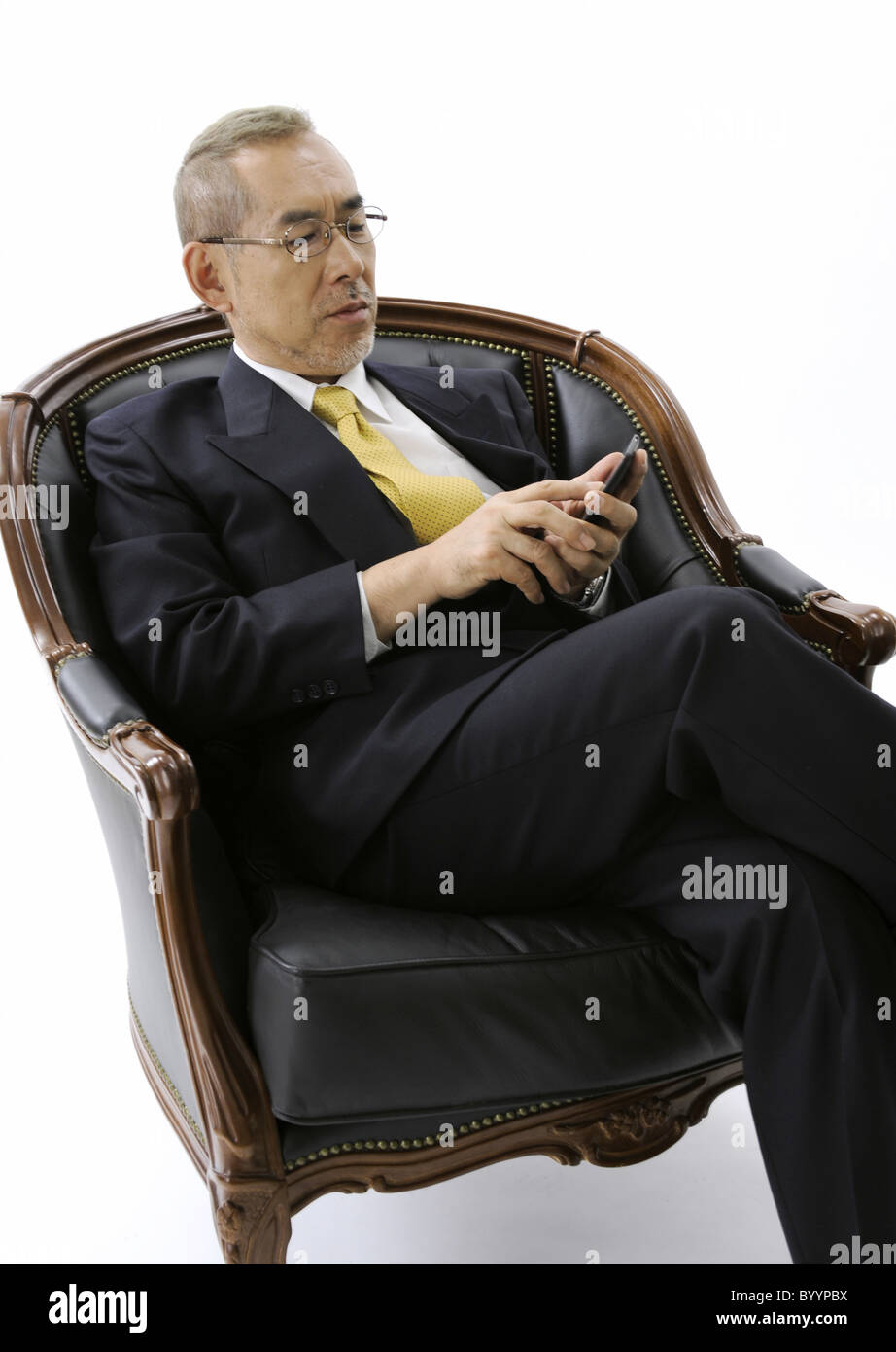 Man sitting cross legged on chair hires stock photography and images