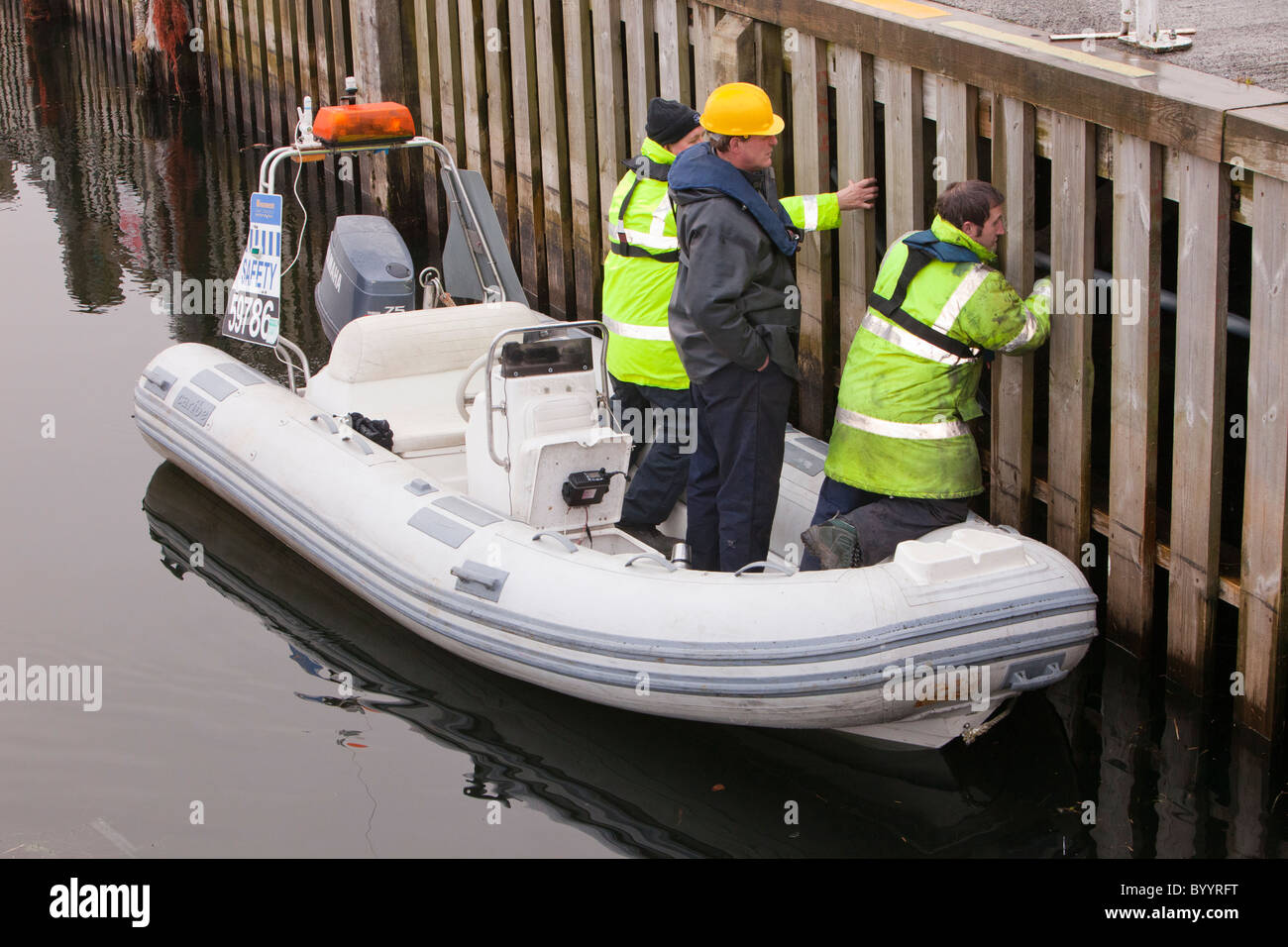 Workmen doing a maintenance check on the Waterhead Jetty at Ambleside