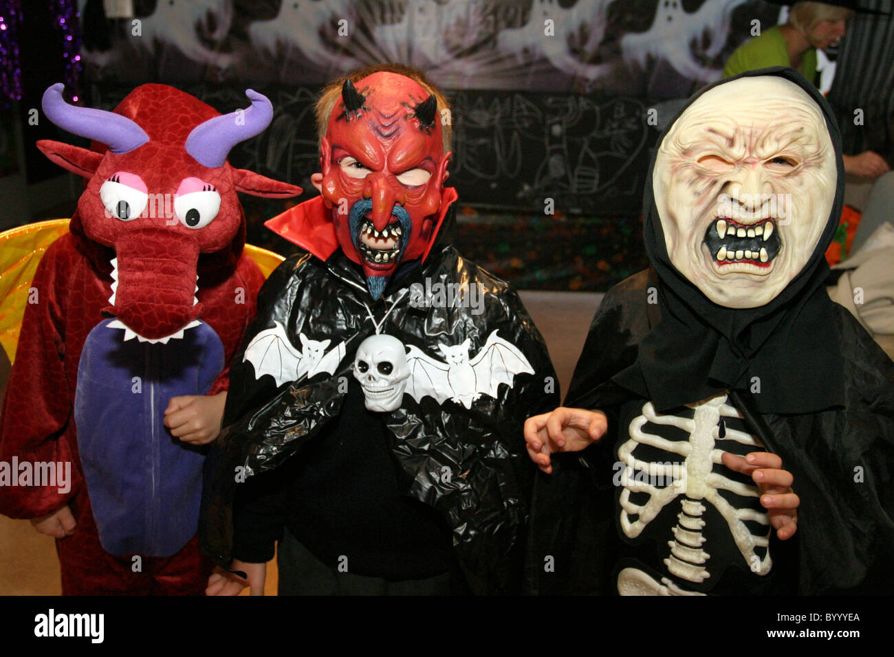Children dressed up in spooky Halloween costumes ready to go trick or treating Stock Photo