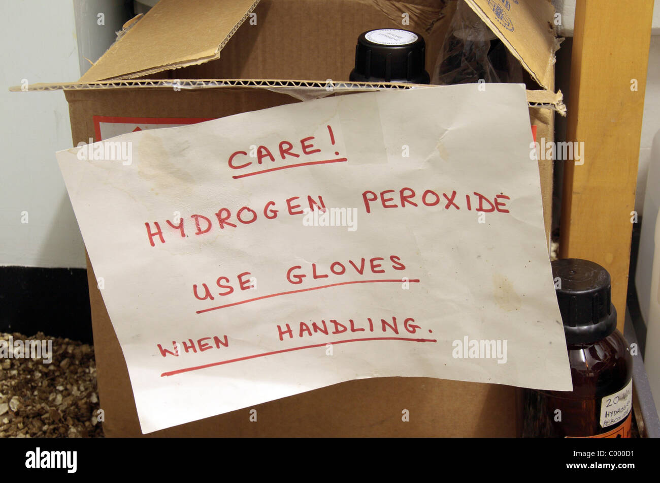 Warning sign on a container of hydrogen peroxide in a school chemical storeroom in London, UK. Stock Photo