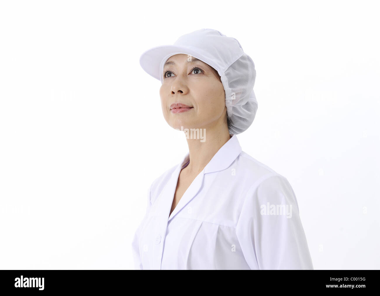 Factory worker looking up into distance Stock Photo - Alamy