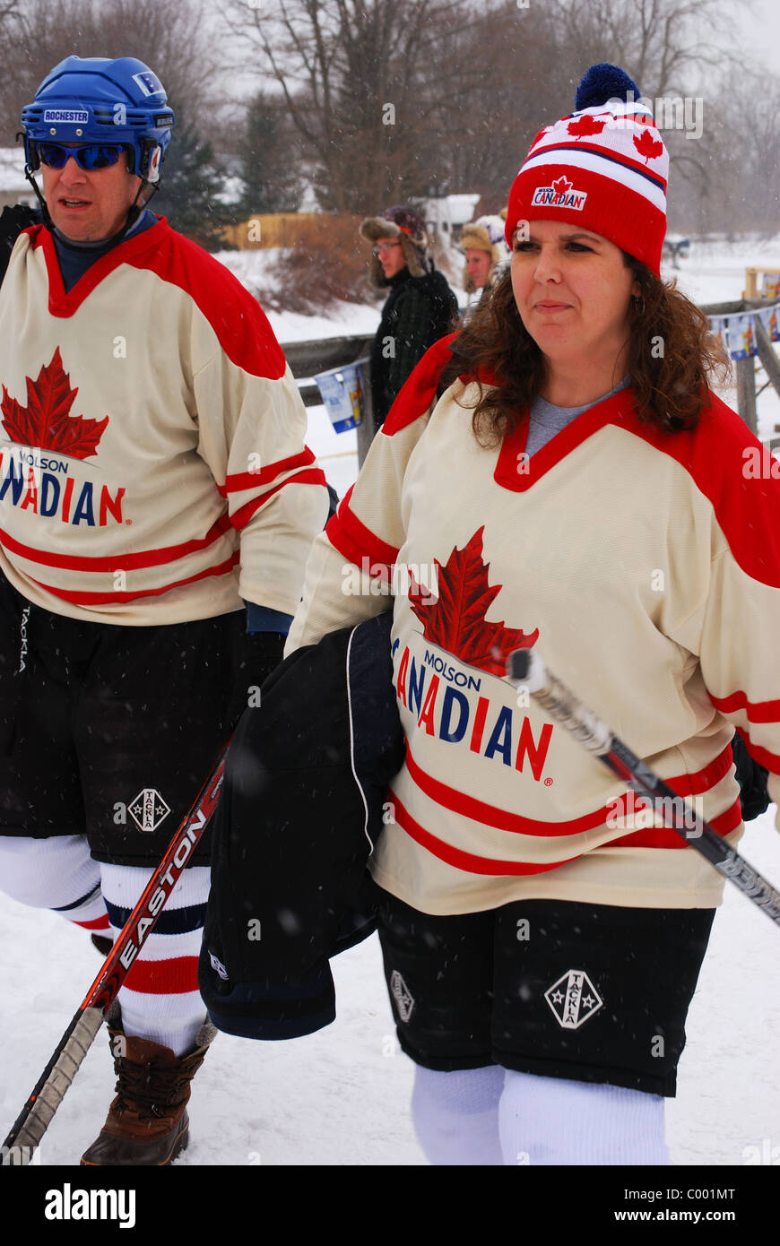 Female and male hockey players played in Pond Hockey Tournament  on Erie Canal. Stock Photo
