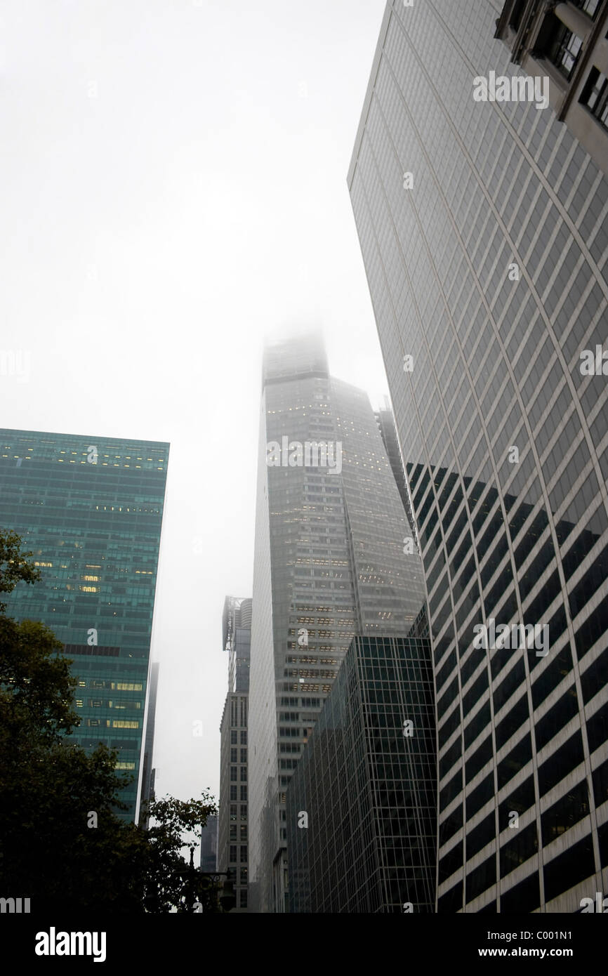 A group of city skyscraper buildings on a gloomy and foggy overcast day. Stock Photo