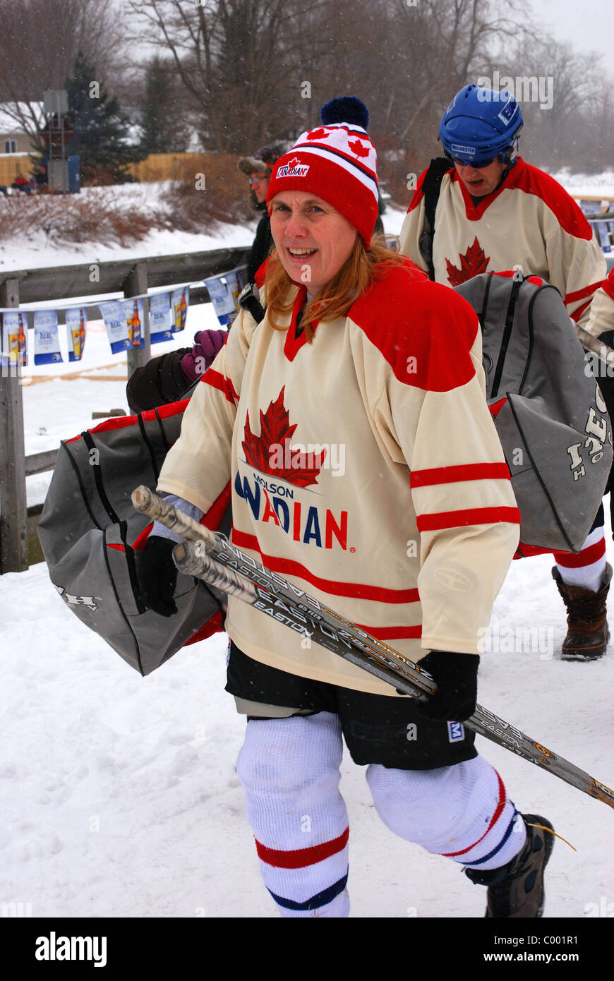 Female hockey player played in Pond Hockey Tournament  on Erie Canal. Stock Photo