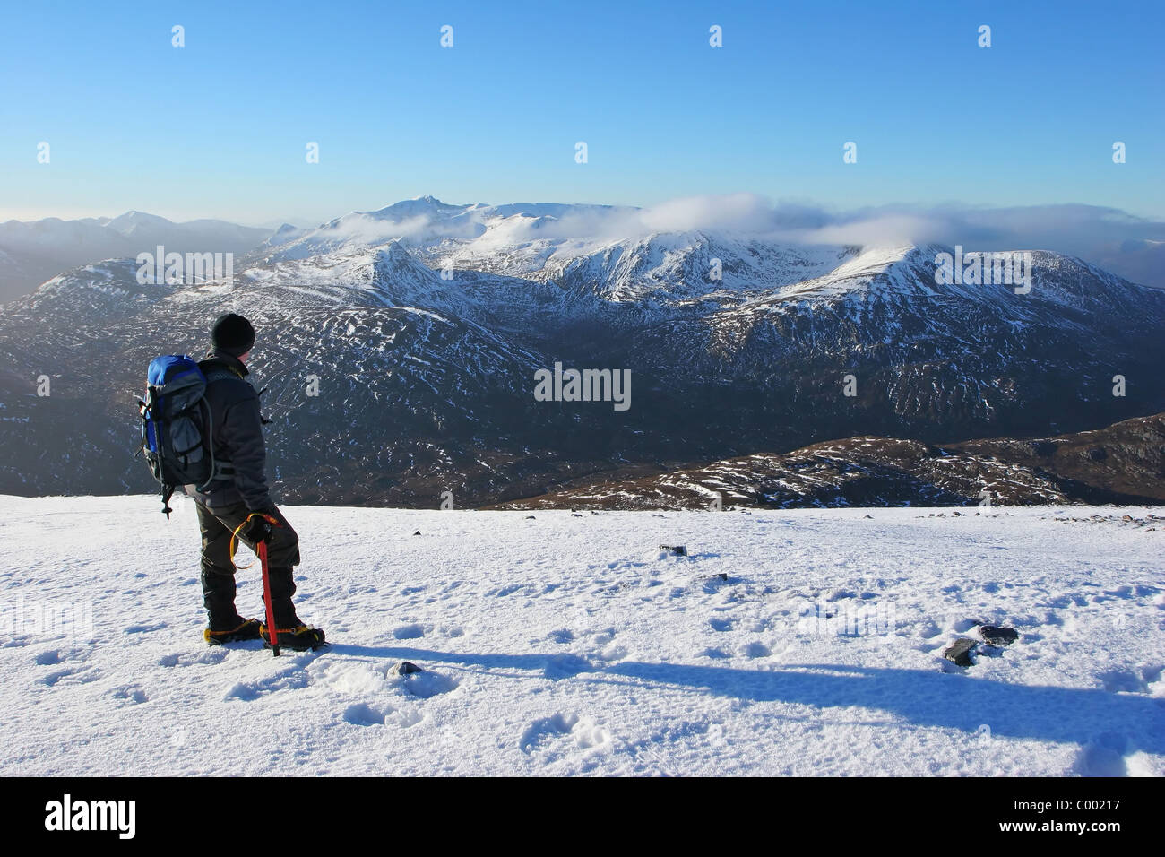 Hiker looking across to The Grey Corries from Stob Coire Easian. Stock Photo