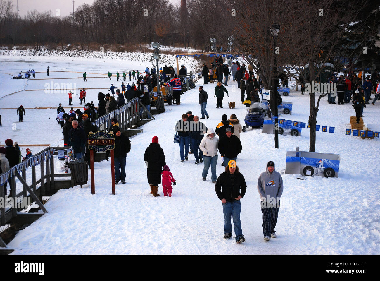 Fans of Pond Hockey tournament watch teams from banks of Erie Canal. Stock Photo