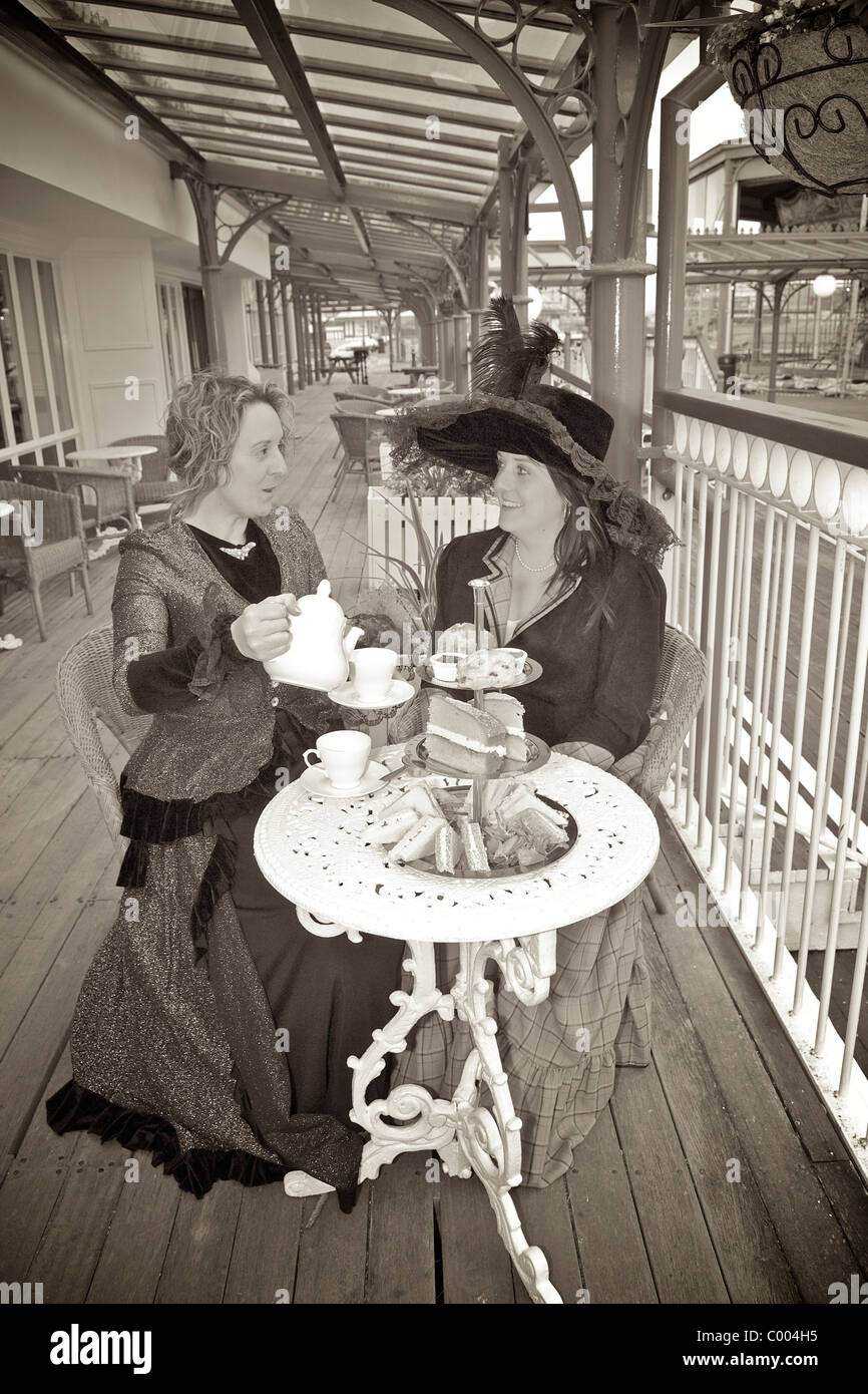 Victorian ladies take tea on the veranda of the North Pier Victorian tearooms,Blackpool,Lancashire,UK Stock Photo