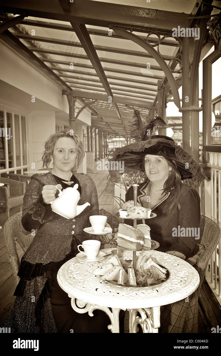 Victorian ladies take tea on the veranda of the North Pier Victorian tearooms,Blackpool,Lancashire,UK Stock Photo