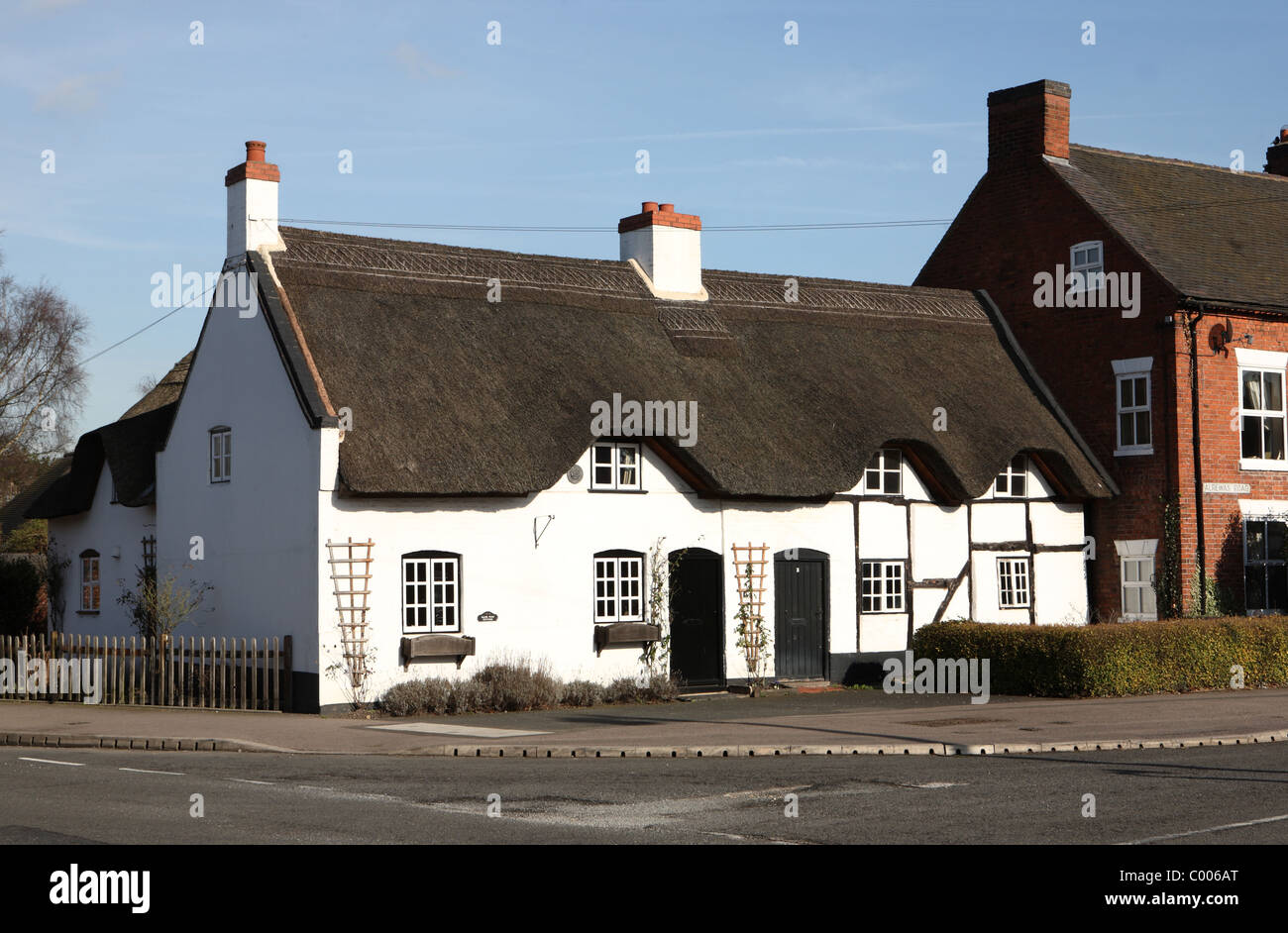 Thatched cottage in village Stock Photo