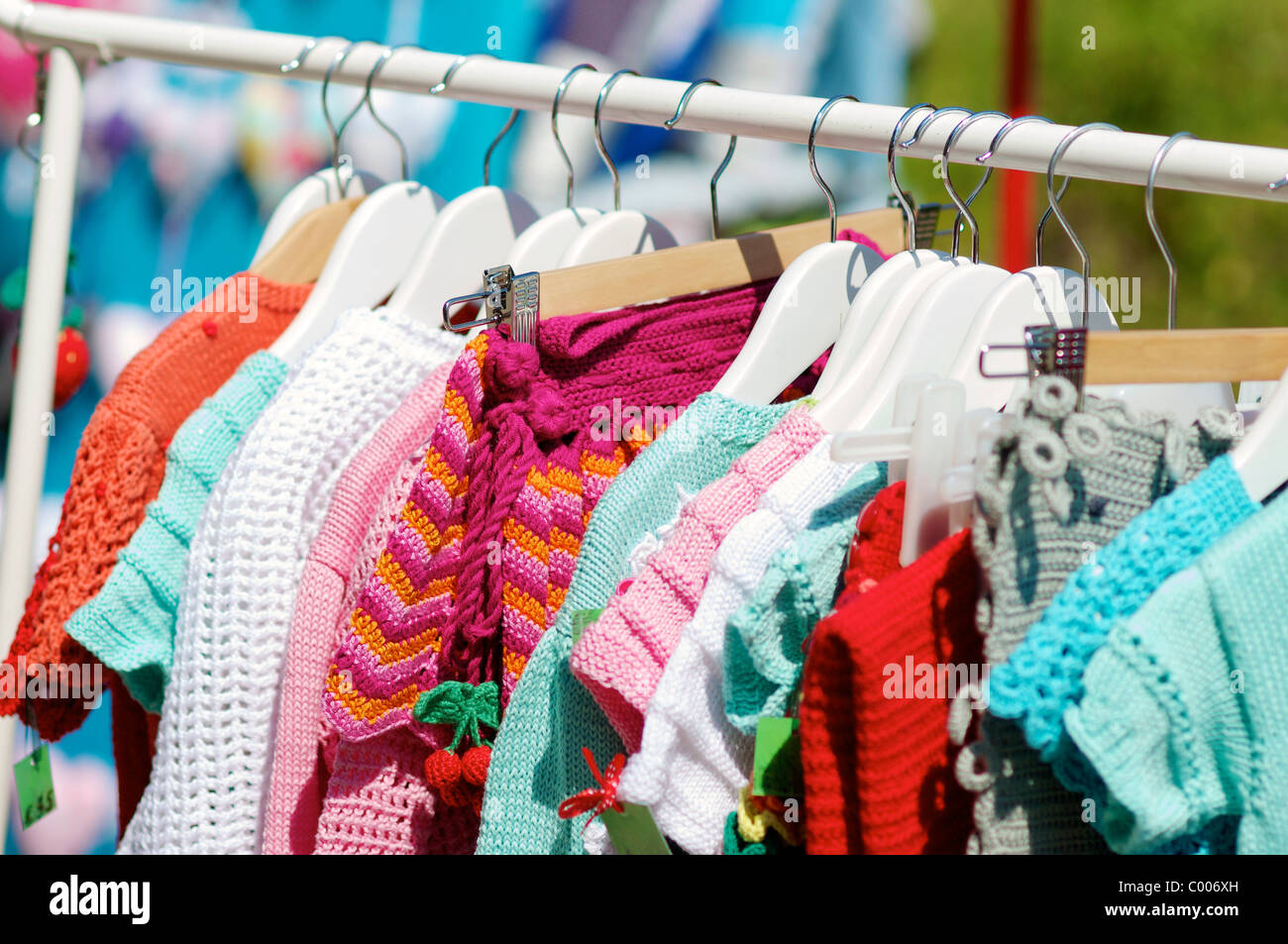Colorful children clothing on a cloth rack on a market in Almere (The