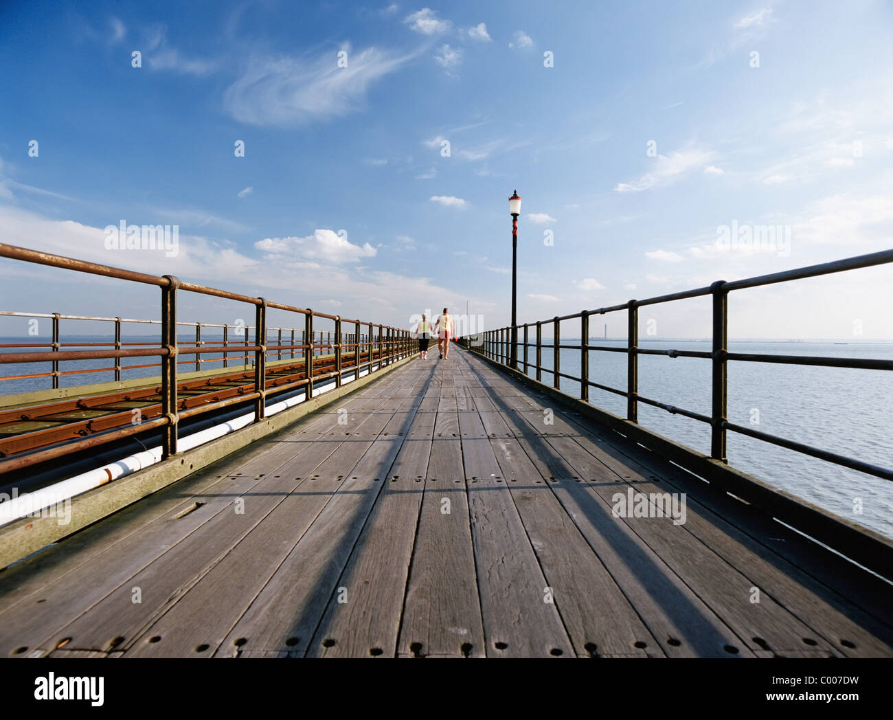 Couple Walking Down Pier Stock Photo - Alamy