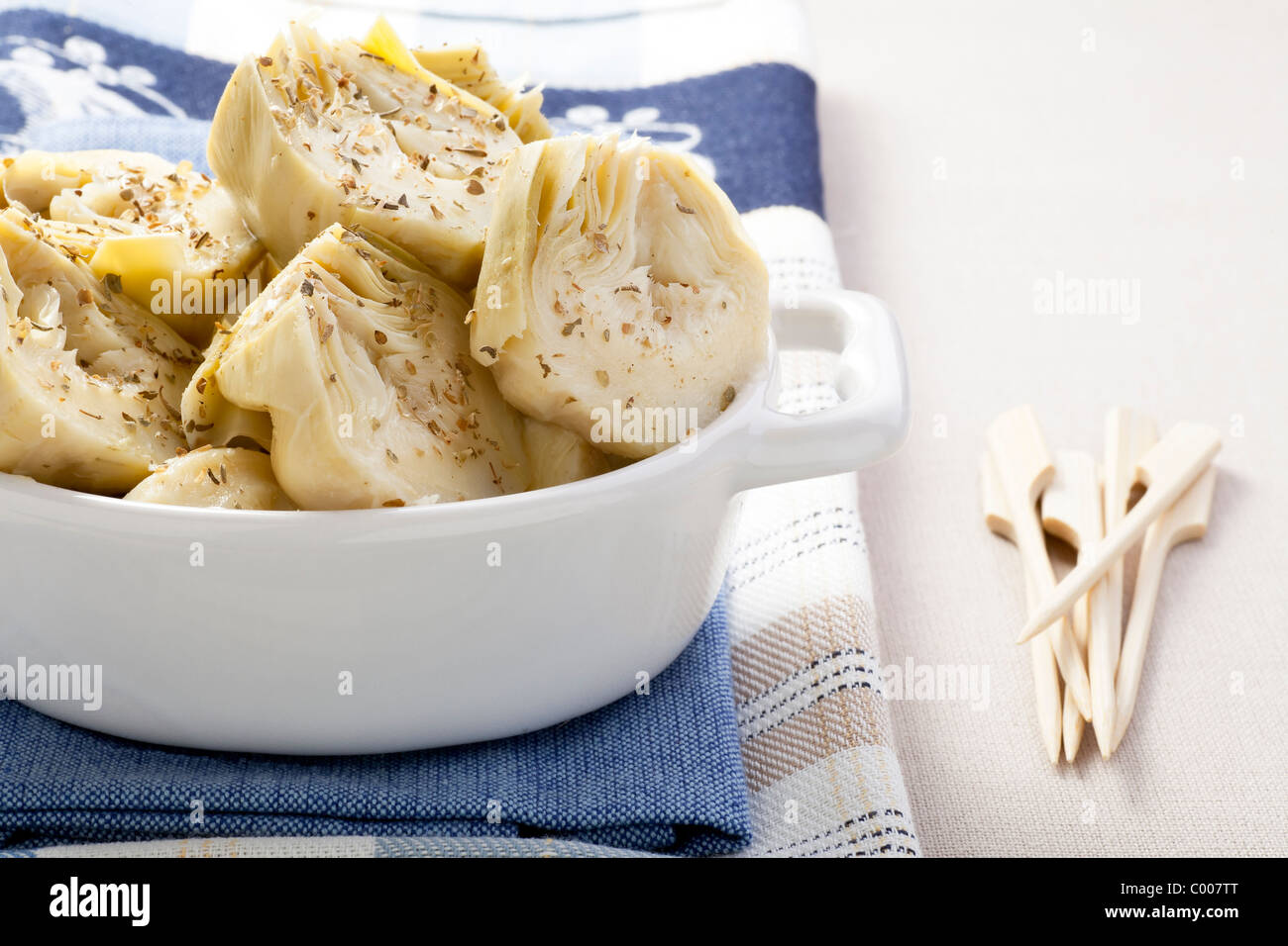 Artichoke hearts covered in herbs served as an appetizer Stock Photo