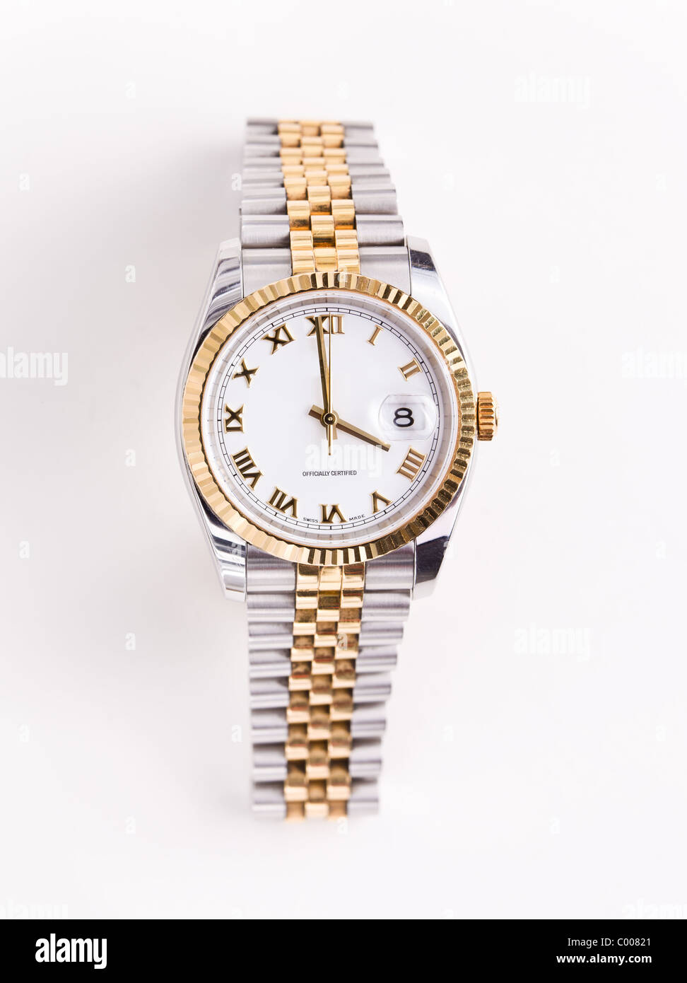 Expensive gold bevelled watch with white face and gold hands and numerals against white background Stock Photo