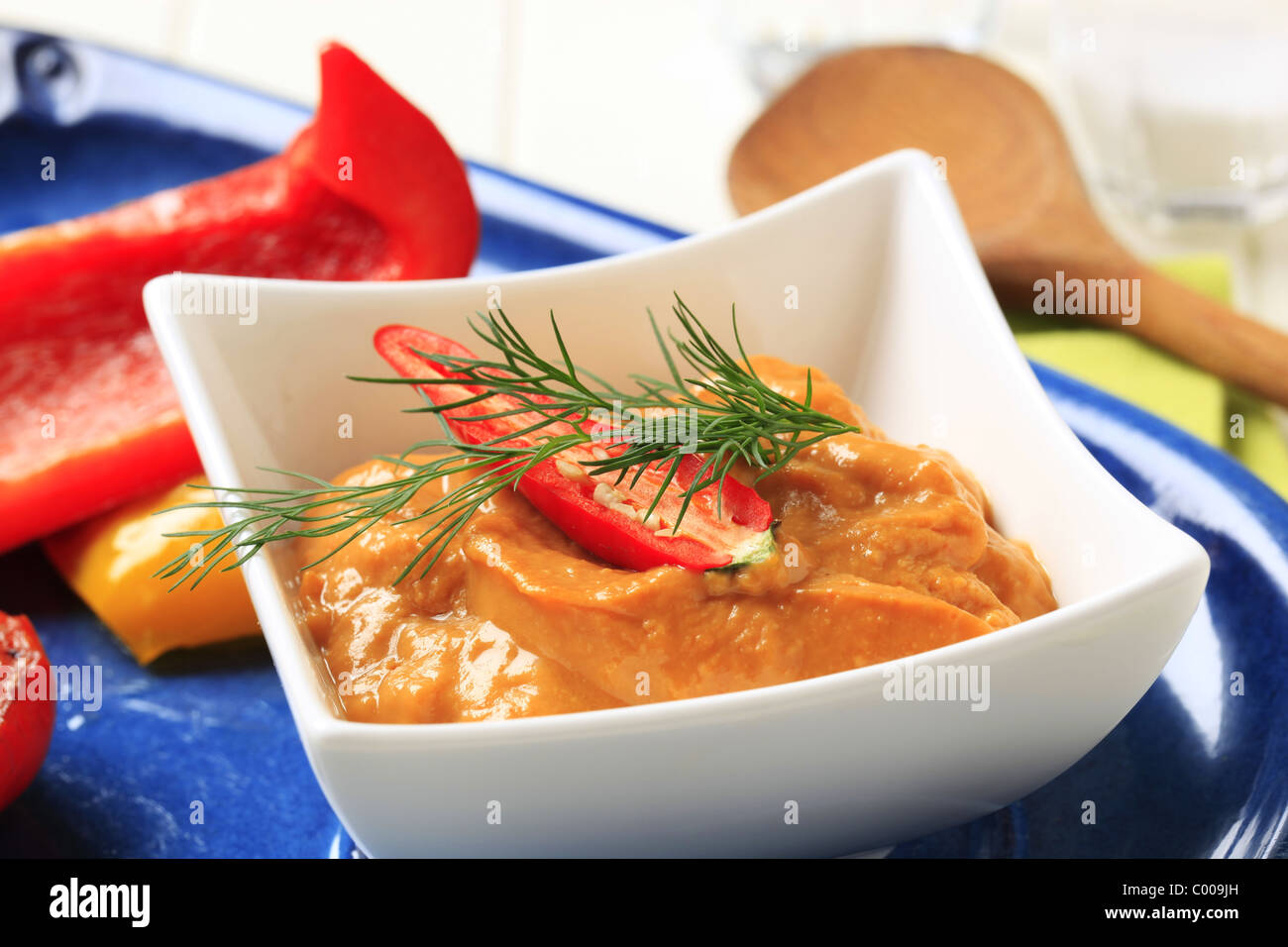 Bell pepper coulis in a small square dish Stock Photo Alamy