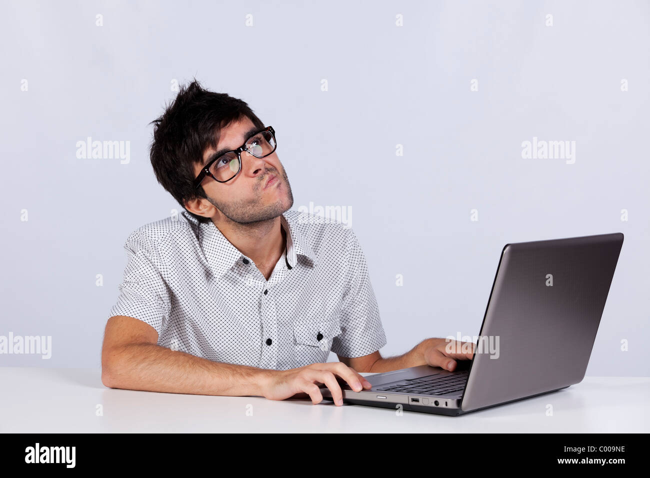 Young man thinking about a solution for a computer problem Stock Photo ...