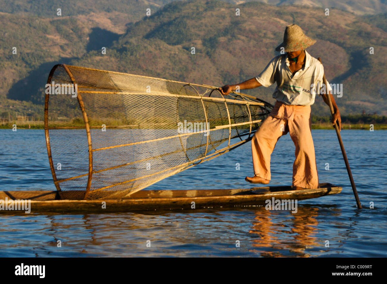 Intha legrowing fisherman with basket net on Inle Lake, Myanmar (Burma