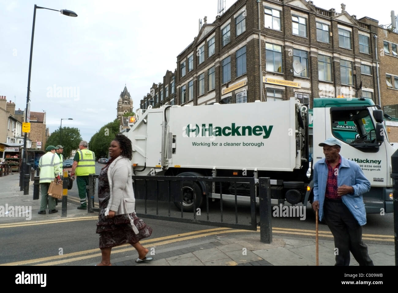 Hackney Borough Council rubbish collection workers and sign on lorry near Ridley Road Market Dalston London England UK Stock Photo