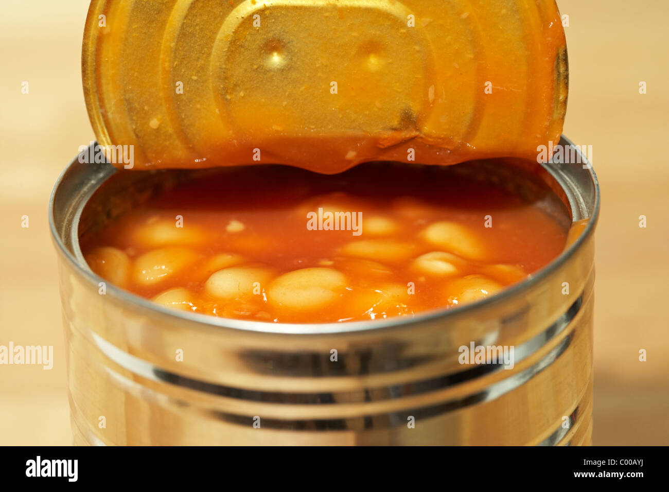 tin can of baked beans in tomato sauce opened with lid peeled back Stock Photo
