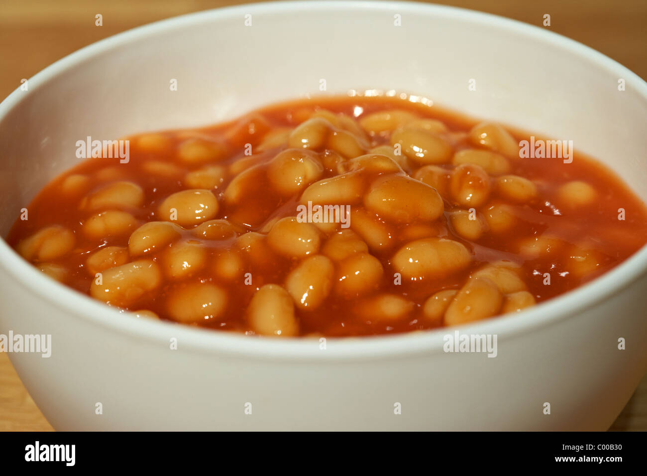 plastic bowl of baked beans in tomato sauce ready for microwave cooking Stock Photo