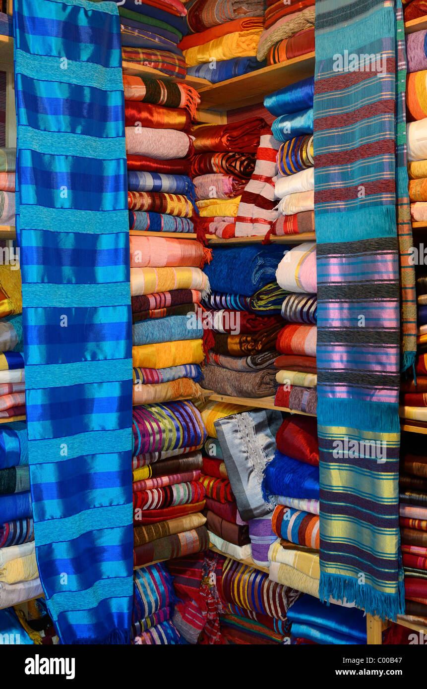 Bright colorful collection of cloth wraps in a Fes el Bali Medina Fez Morocco textile shop Stock Photo