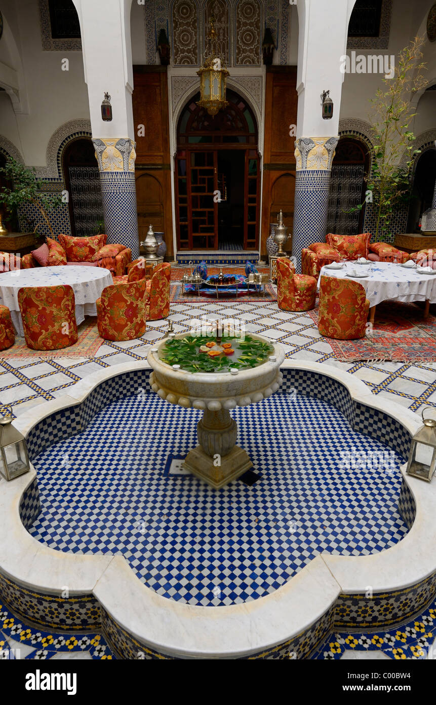 Fountain and dining area in Moorish style inside Riad El Yacout in Fes el Bali Morocco Stock Photo