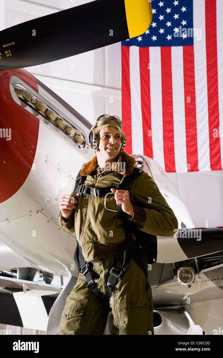 Pilot with vintage fighter plane and American flag Stock Photo