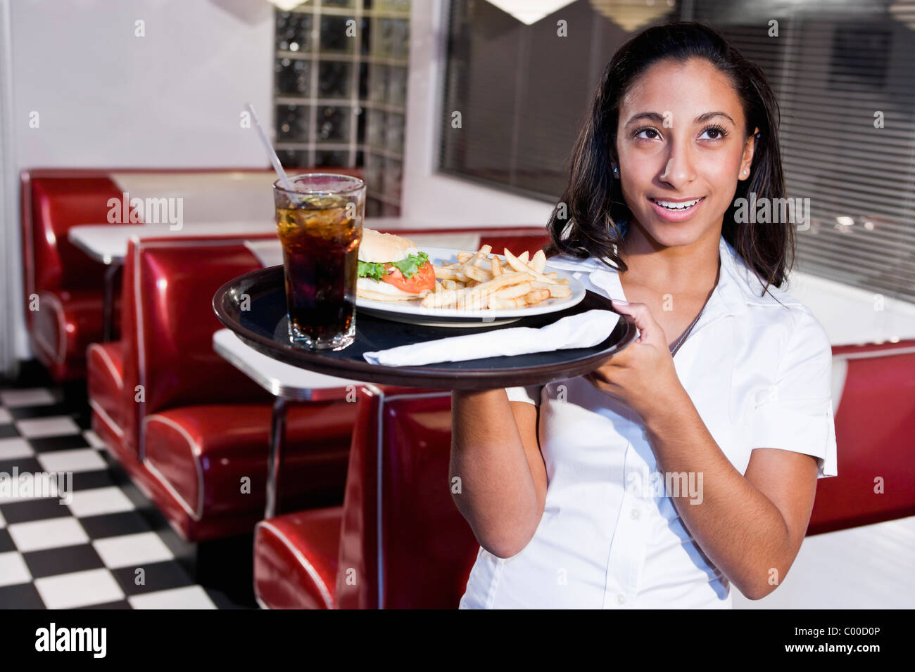 African American waitress serving lunch in diner Stock Photo