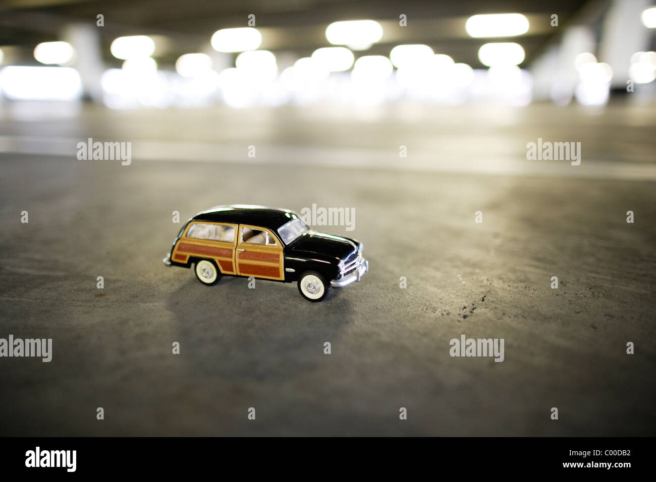 Toy car in empty car park. Stock Photo