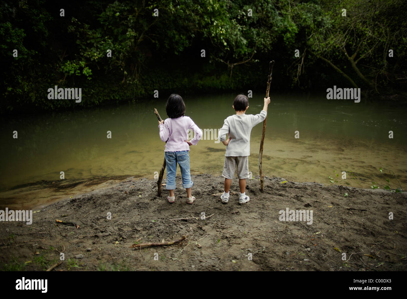 Boy girl hold sticks look hires stock photography and images Alamy