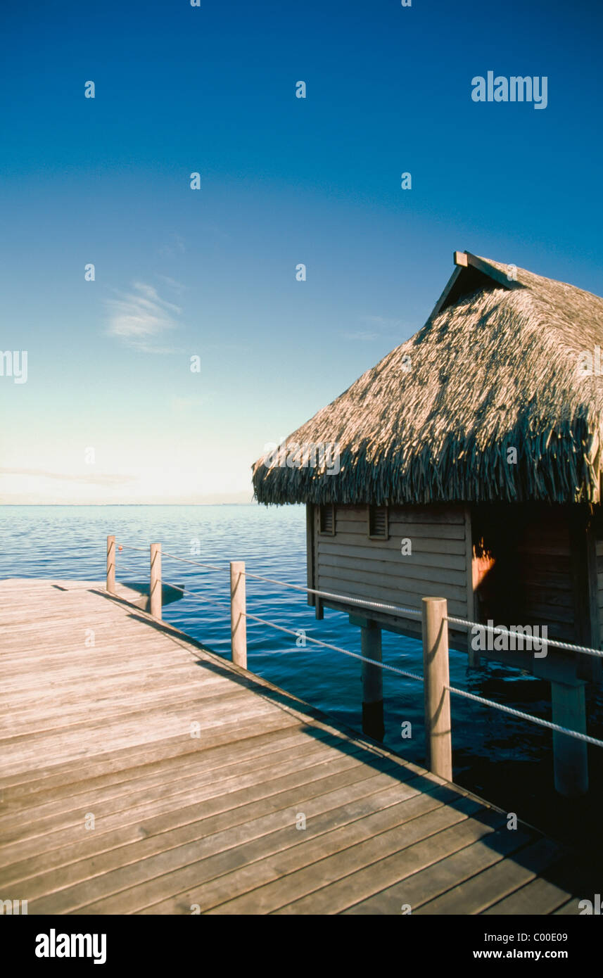Wooden Hut On Stilts With Jetty In Sea Stock Photo