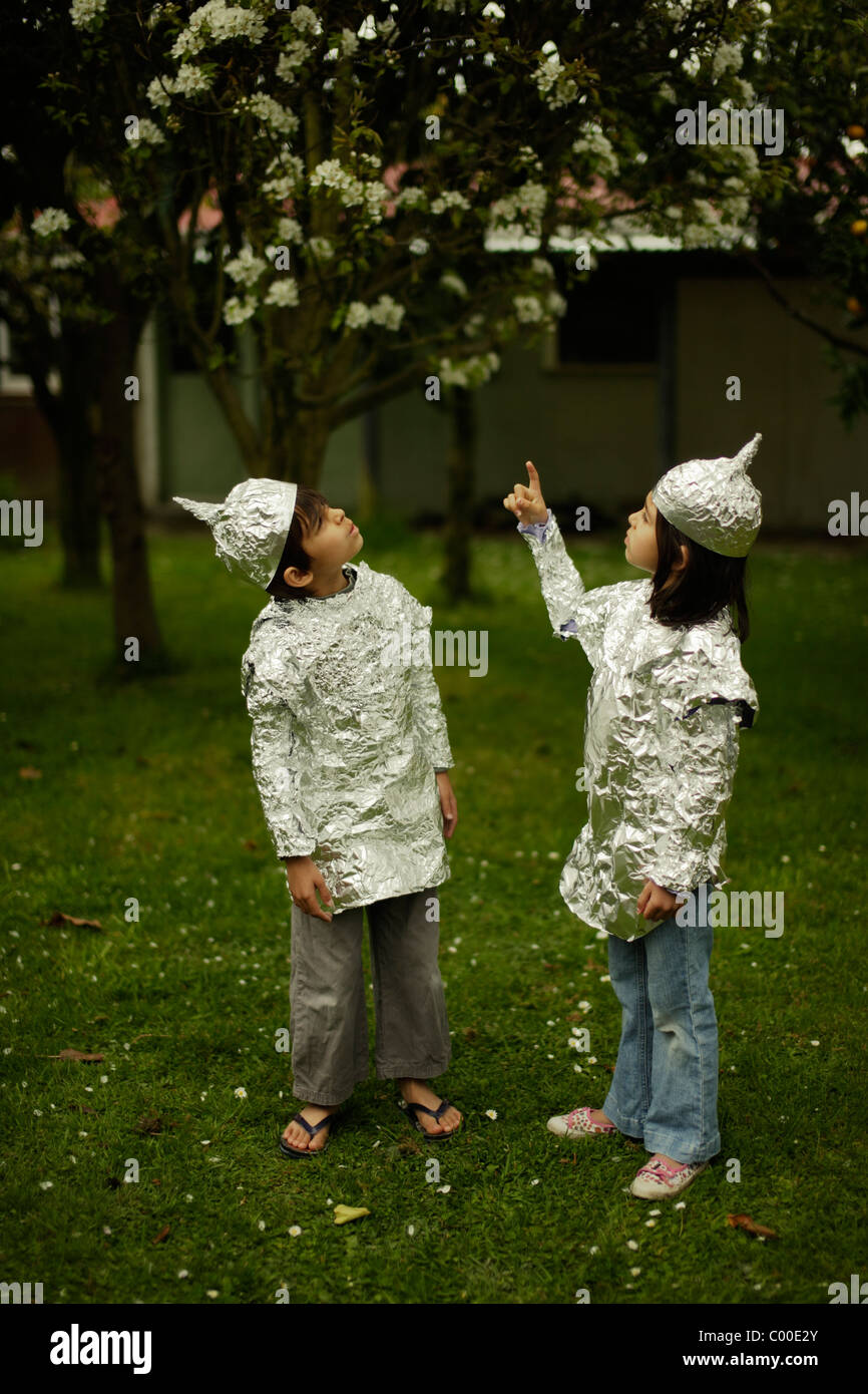 Children wear protective baking foil whilst watching out for possible alien invasion. Stock Photo