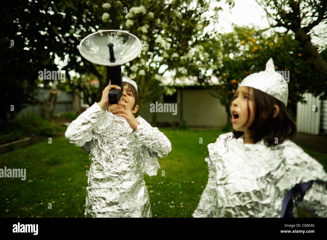 Children wear protective baking foil whilst watching out for possible alien invasion. Stock Photo