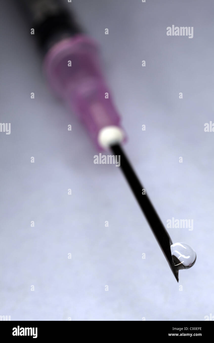 Syringe and needle with drop of clear liquid Stock Photo Alamy