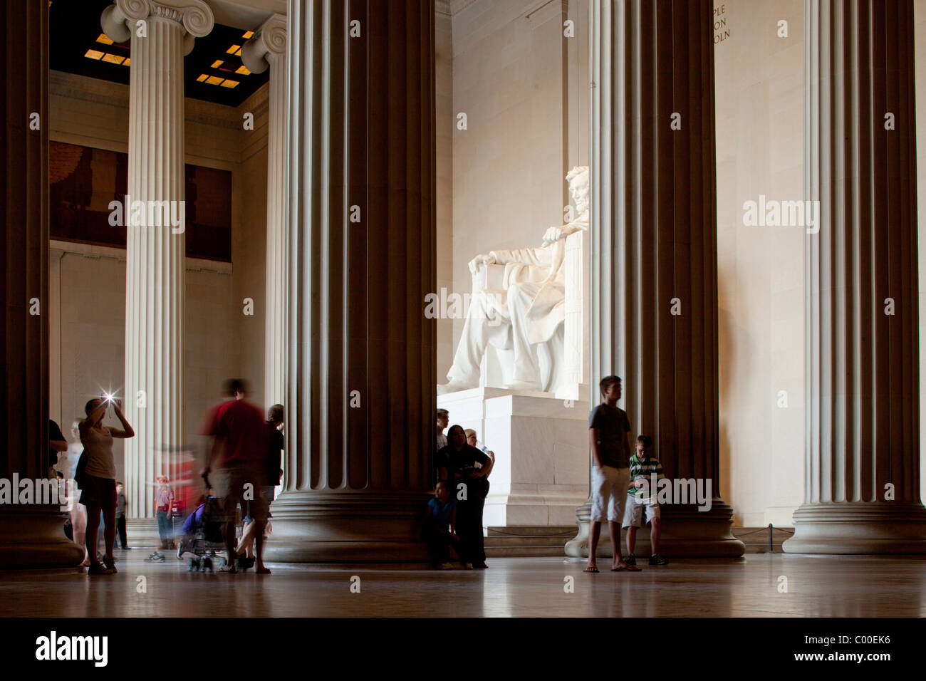 USA, District of Columbia, Washington, DC, Tourists visit shadowy interior of Lincoln Memorial on summer evening Stock Photo