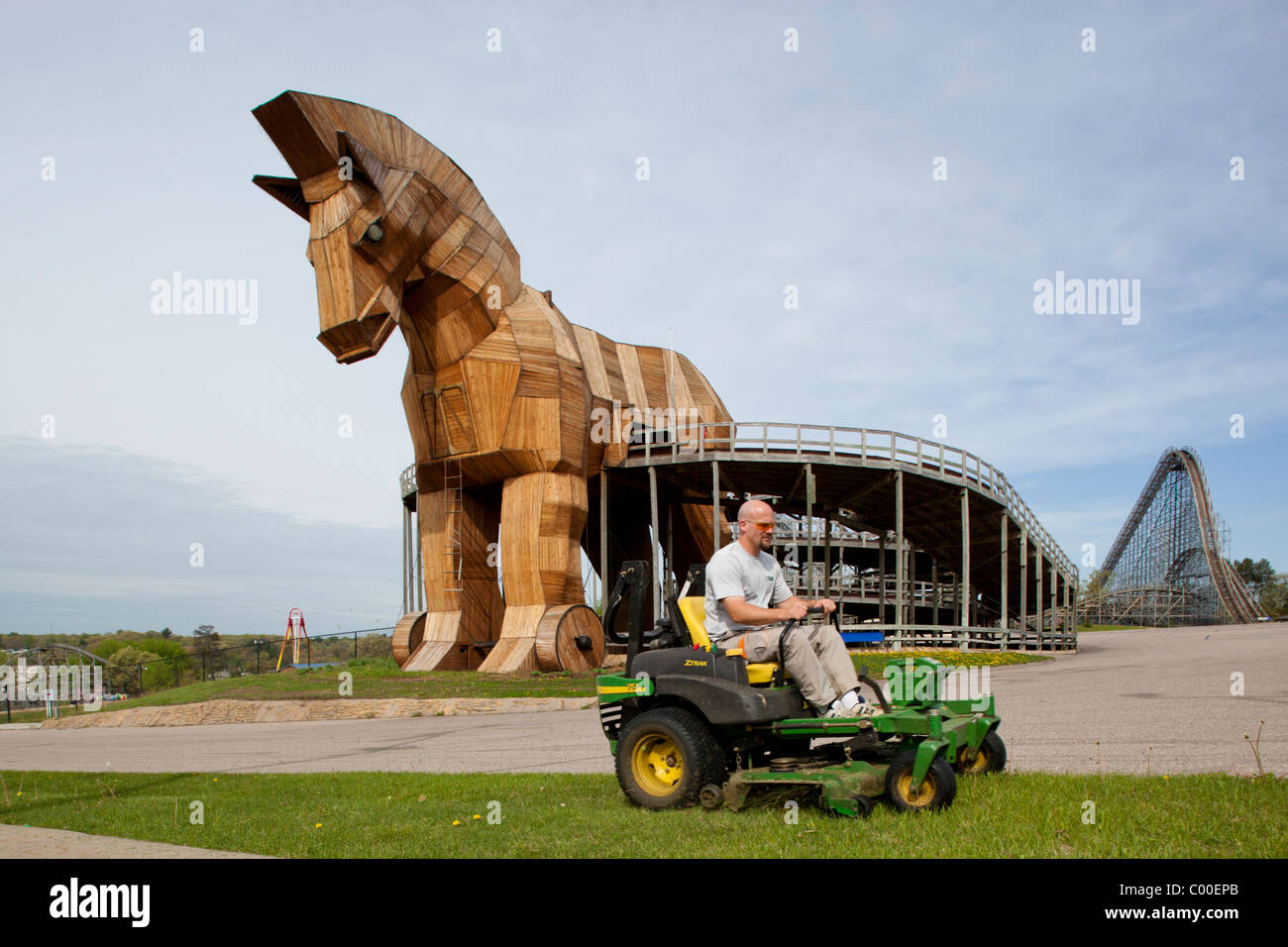 USA, Wisconsin, Wisconsin Dells, Maintenance worker drives lawn mower past Replica of Trojan Horse at Mt. Olympus Amusement Park Stock Photo