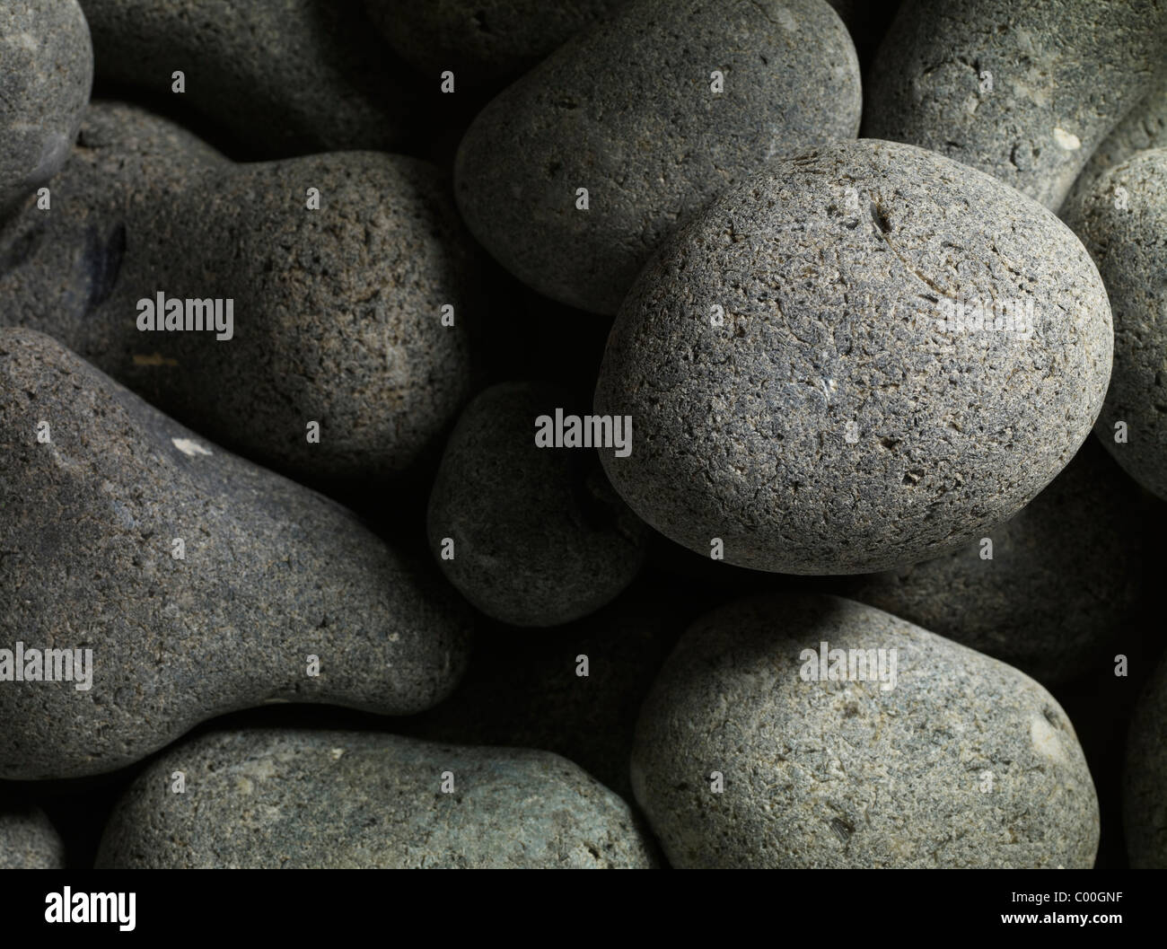 granite pebbles round and smooth forming an abstract background Stock Photo