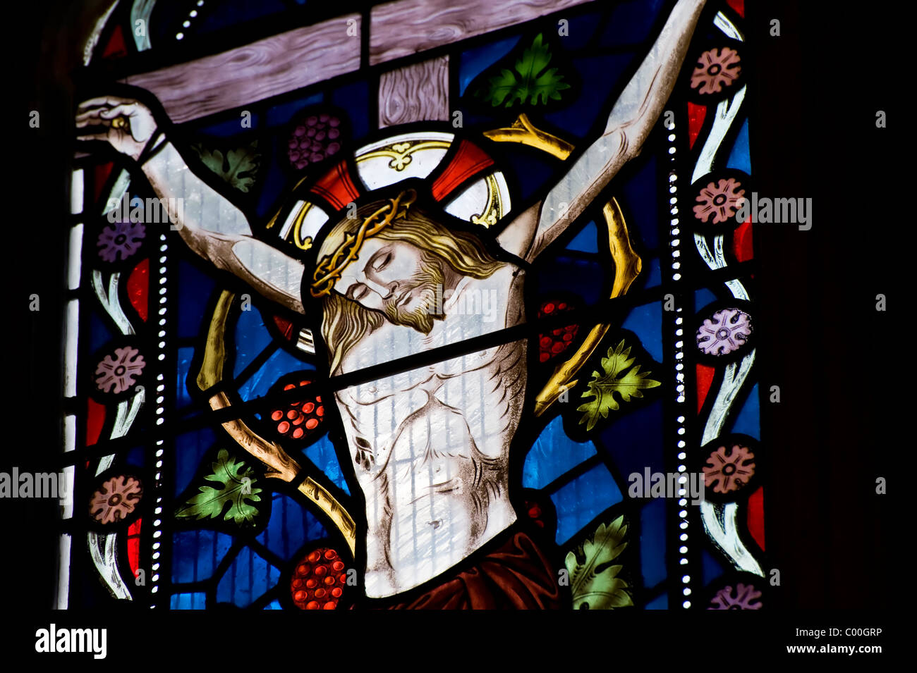 Beautiful stained glass window depicting Jesus on the crucifix Stock