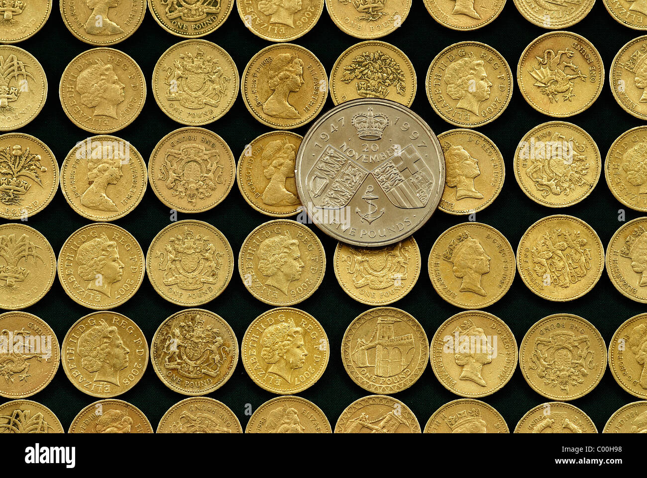 Sterling five pound commemorative coin and regular one pound coins. UK