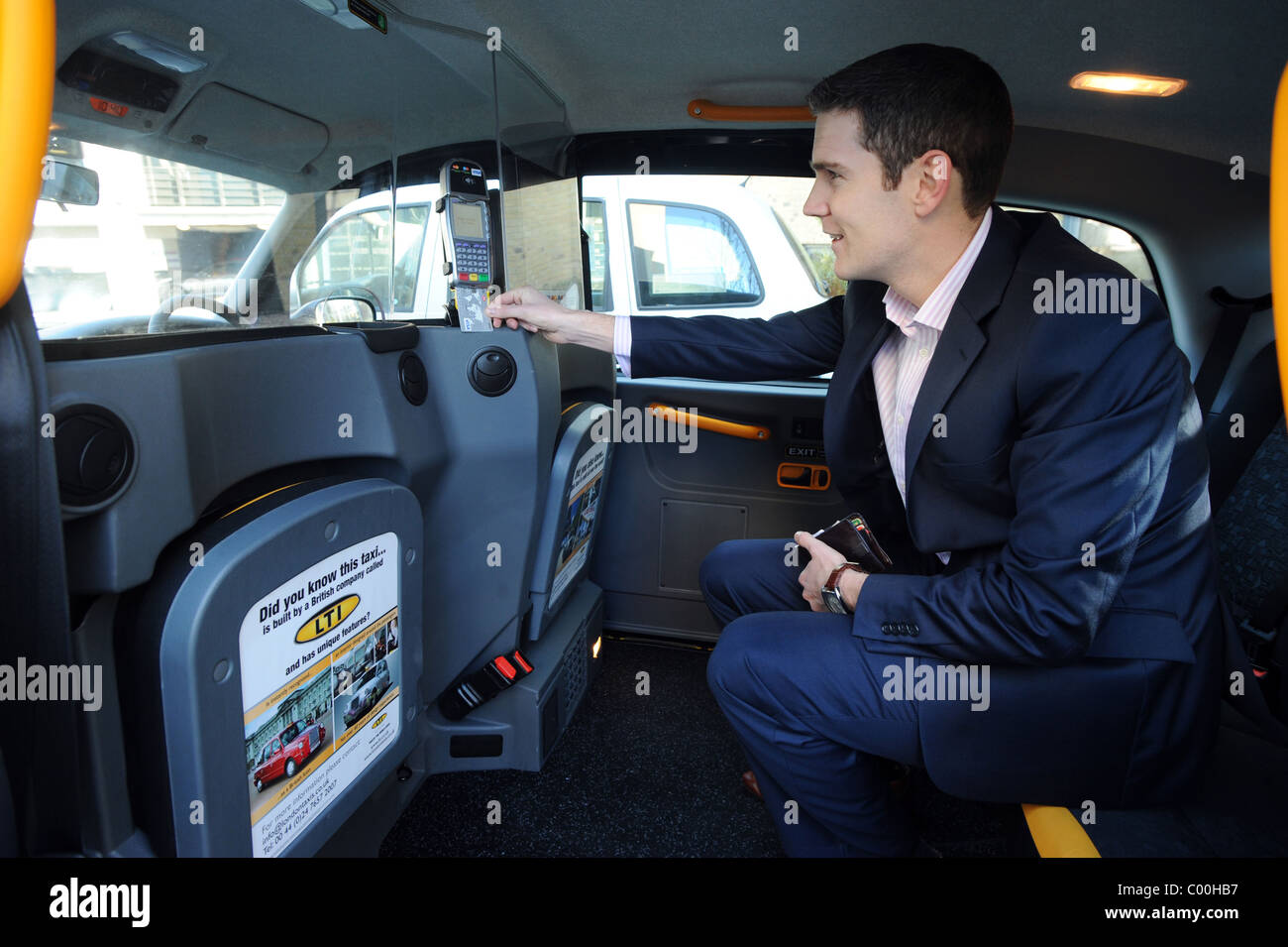 A man pay for a Taxi using a newly installed Verifone machine which