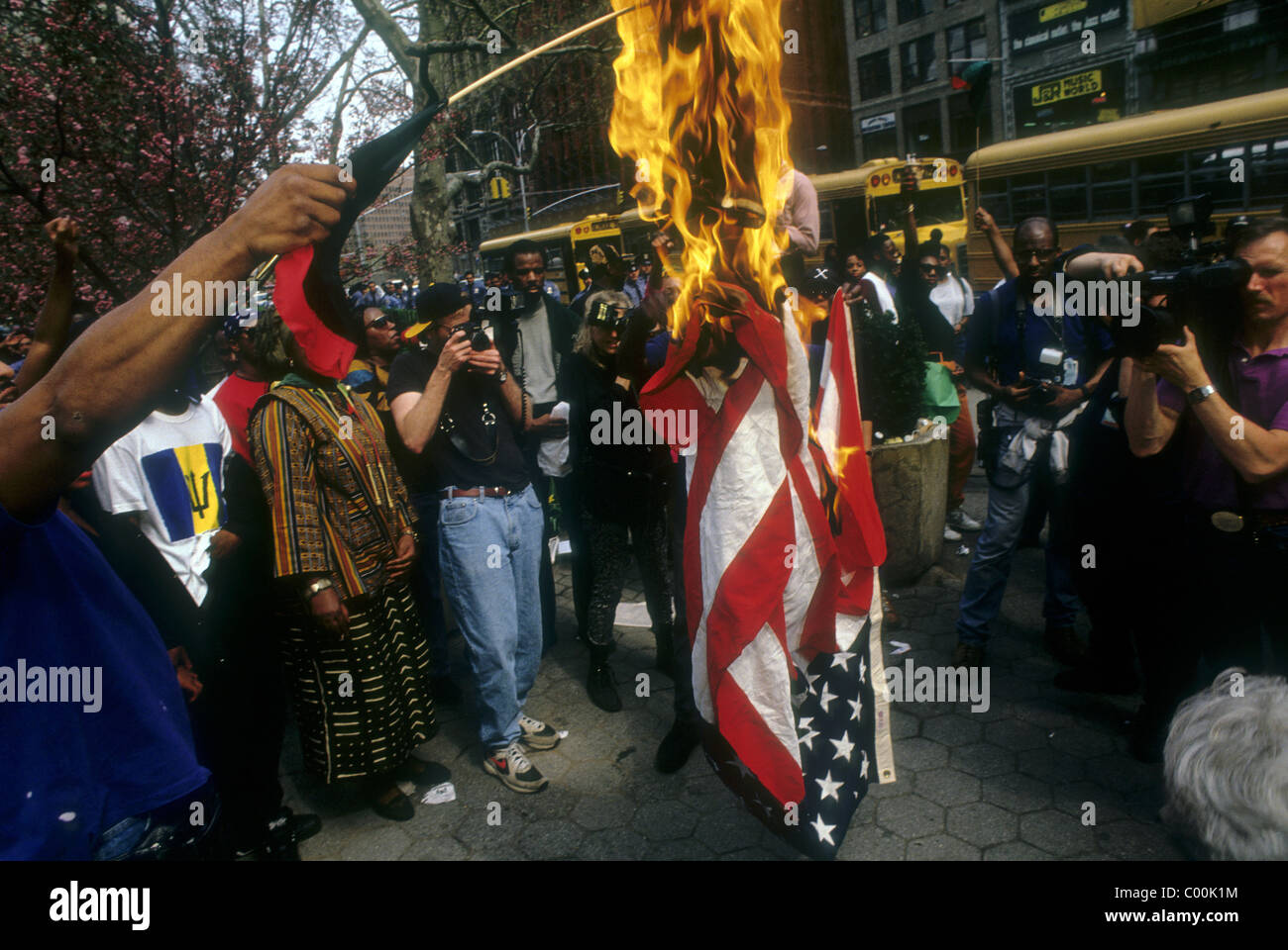 Protesters burn United States Flag during an anti-racism demonstration in New York City Hall Park Stock Photo