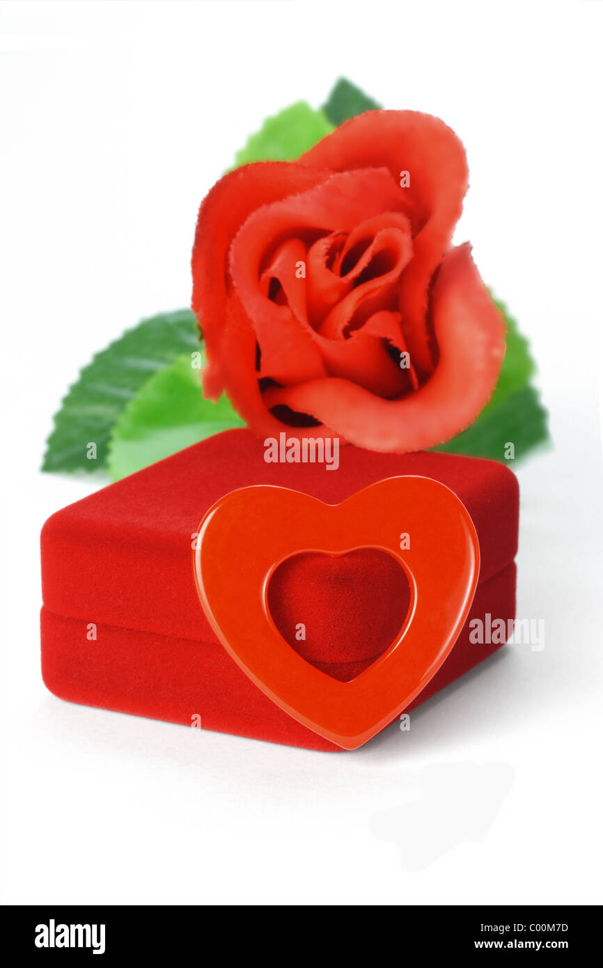 Heart shape symbol on gift box and rose on white background Stock Photo