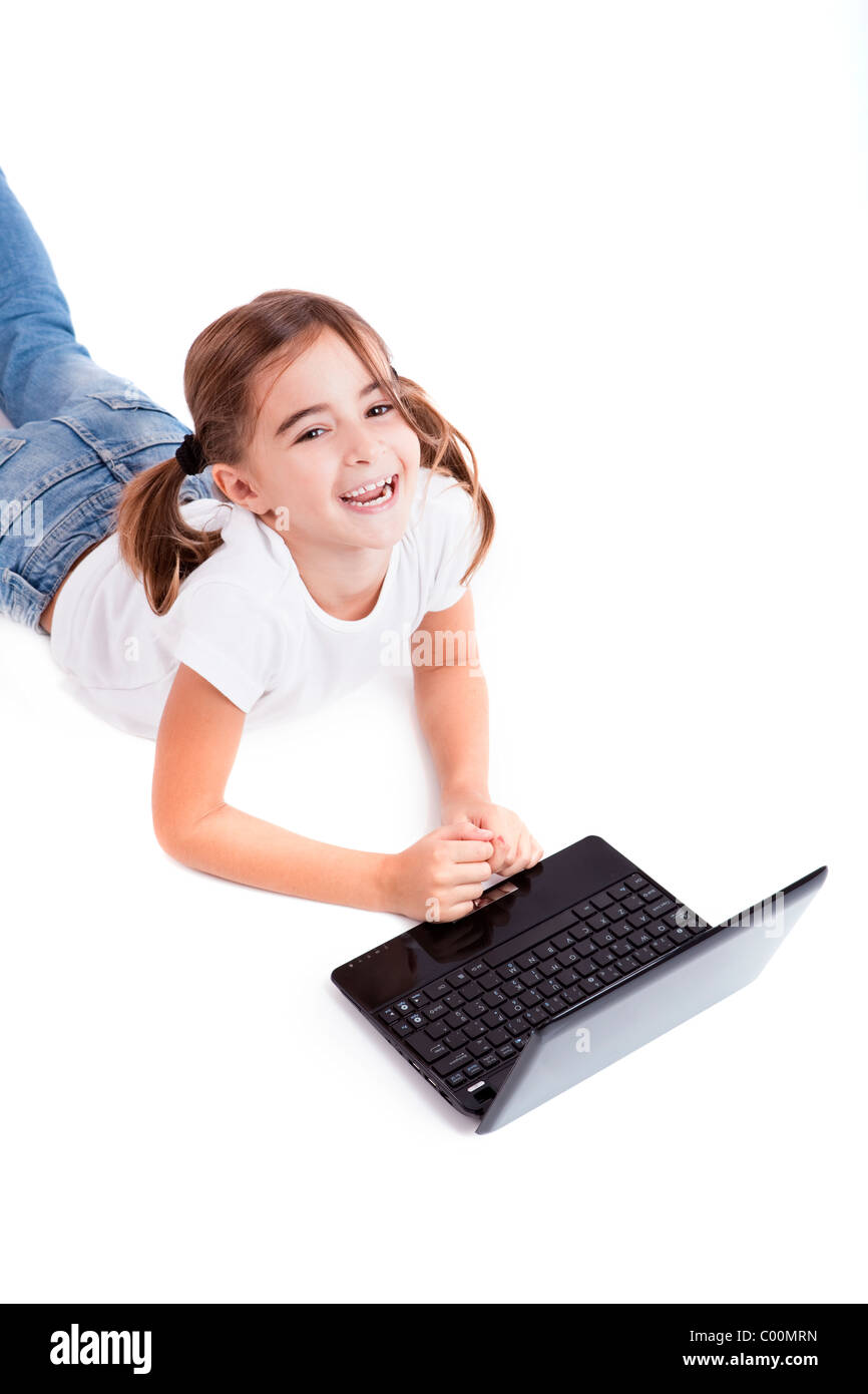 Little girl lying on floor working with a laptop Stock Photo - Alamy
